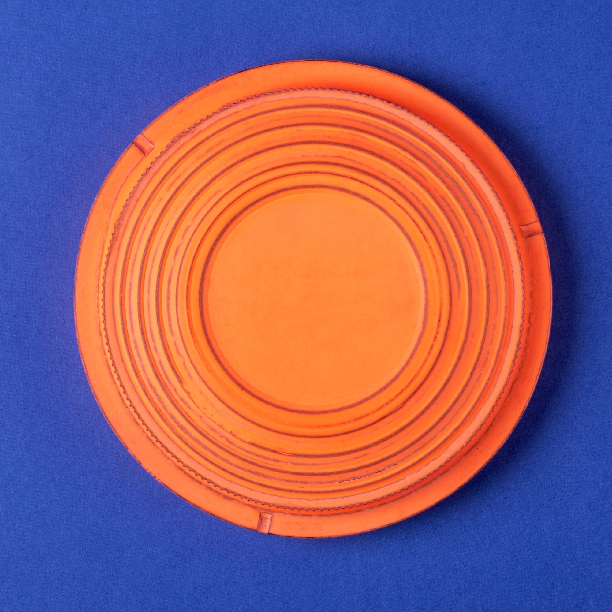 Clay target for skeet shooting against the blue background