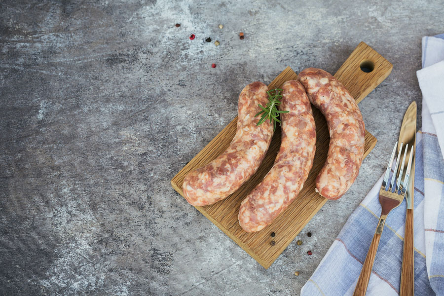 Raw homemade sausages with peppercorn and rosemary herb